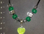 24" handmade  necklace with silver spacers and a green heart pendant