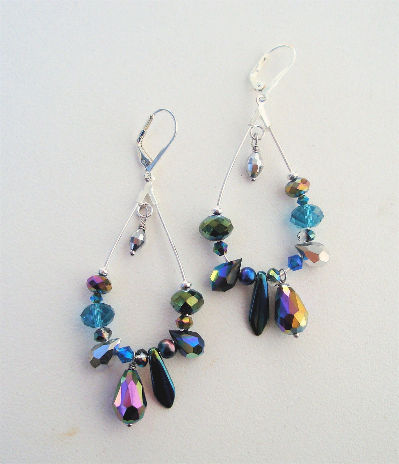 Silver elongated hoop earrings with multi colored and silver crystals and glass beads. Very light weight and fun to wear.