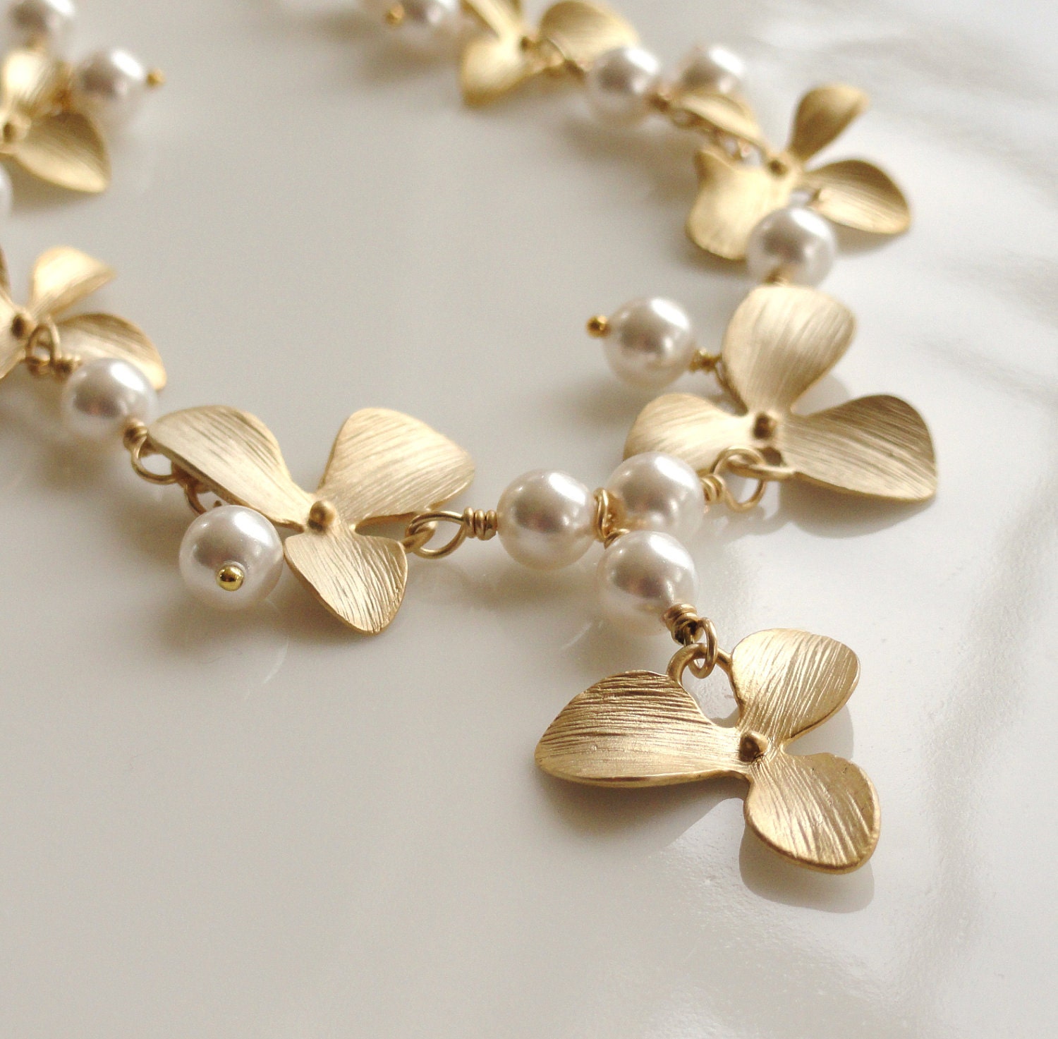 Calliope   ...matte gold flowers and Swarovski glass pearl necklace.