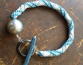 Bead Crochet Rope Bracelet with pearl-grey and metallic-blue stripes on white ground and unique Toggle-clasp - DianaCoe