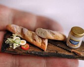 Sandwich in the making on rustic board