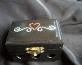 Mini jewelry box in black with 3 carved hearts in the front embellished with rhinestones and fully lined with felt