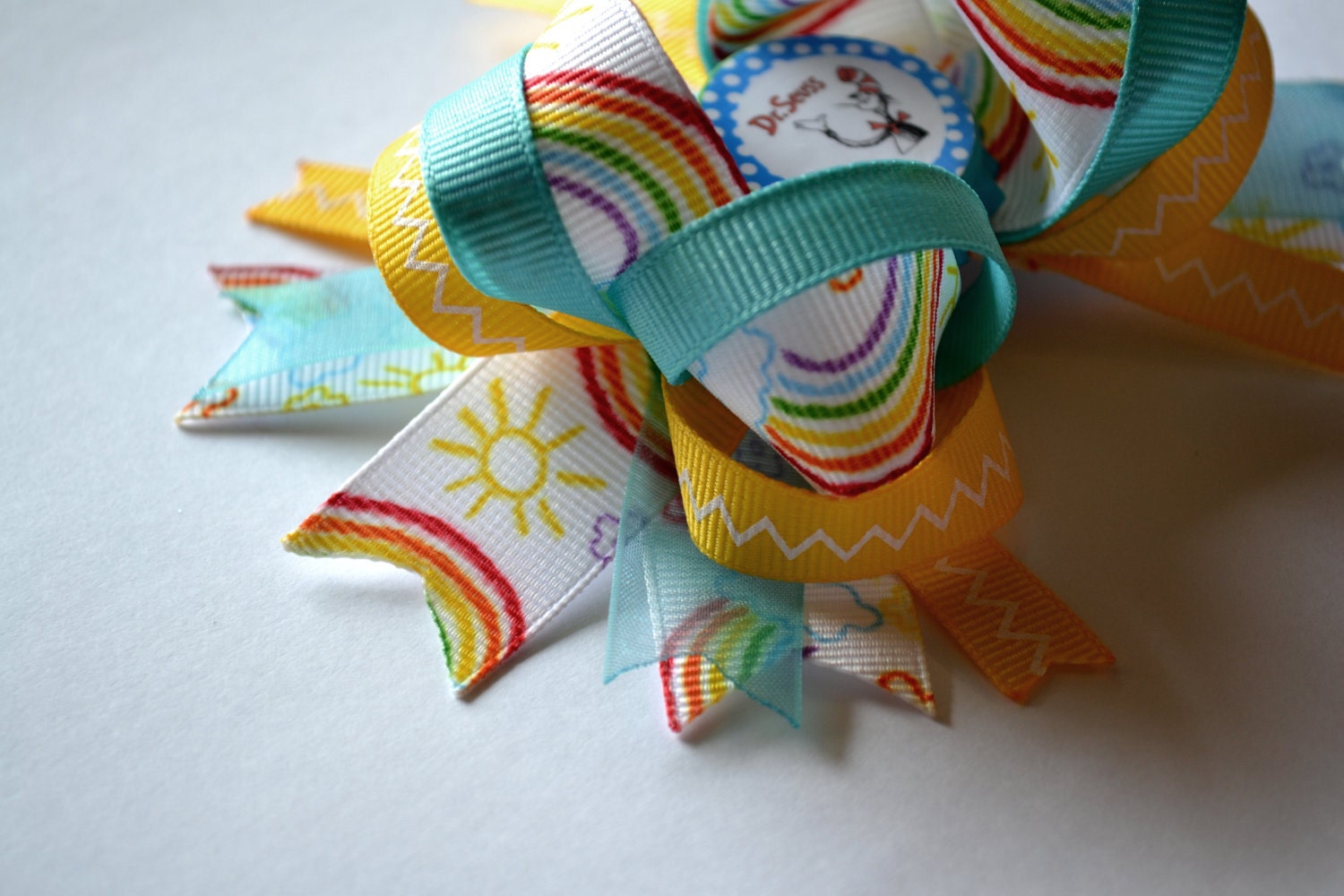 Bright rainbow Dr. Suess Cat in the Hat bottlecap hair bow.