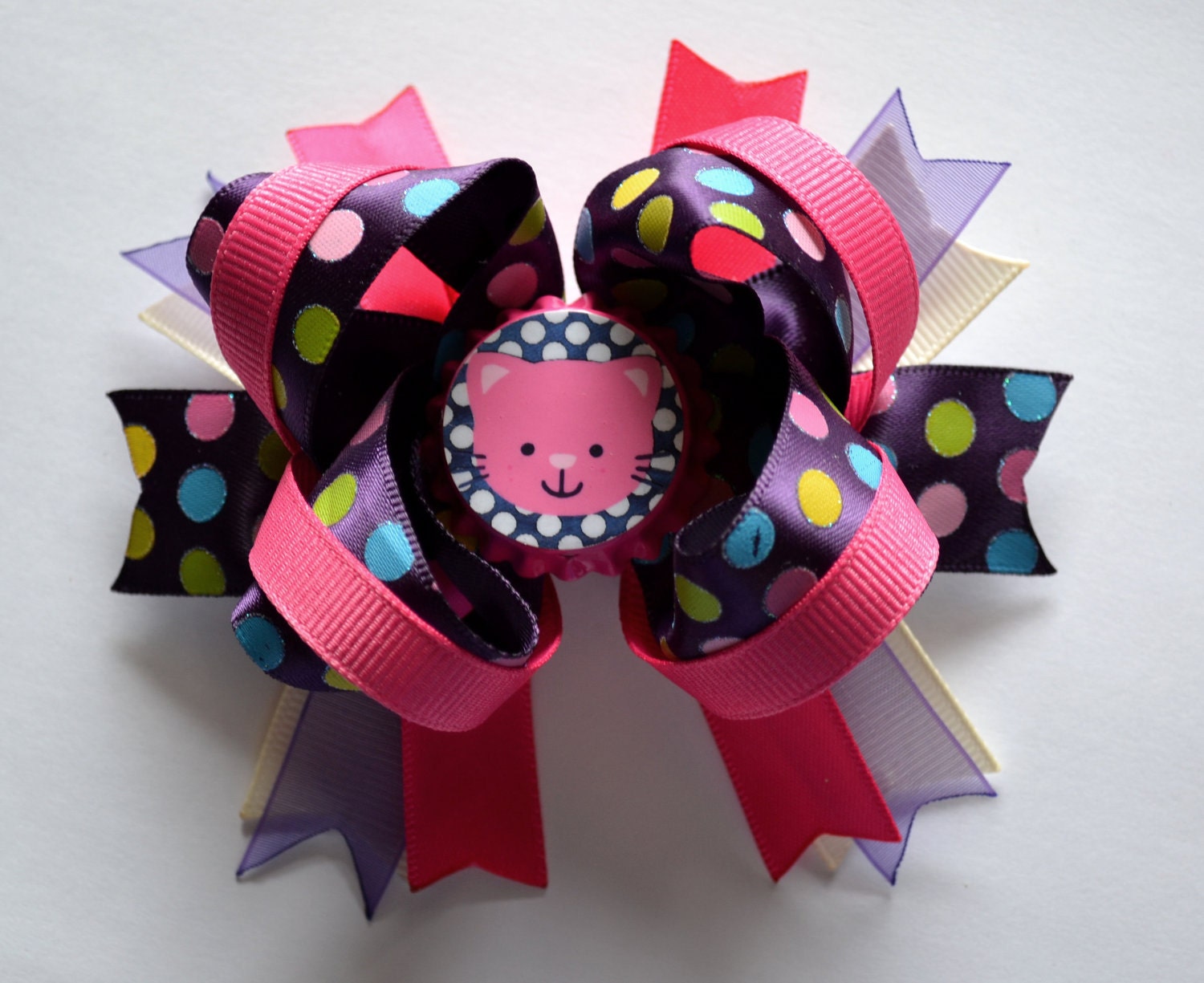 Super cute cat bottle cap hair bow. Pink and purple.