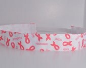 Band-It Headband .... Pink Ribbon.  Will stay put and not slip.