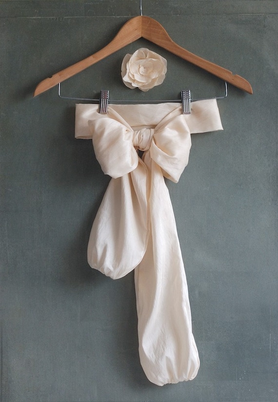 Cream taffeta bow belt and magnolia flower brooch