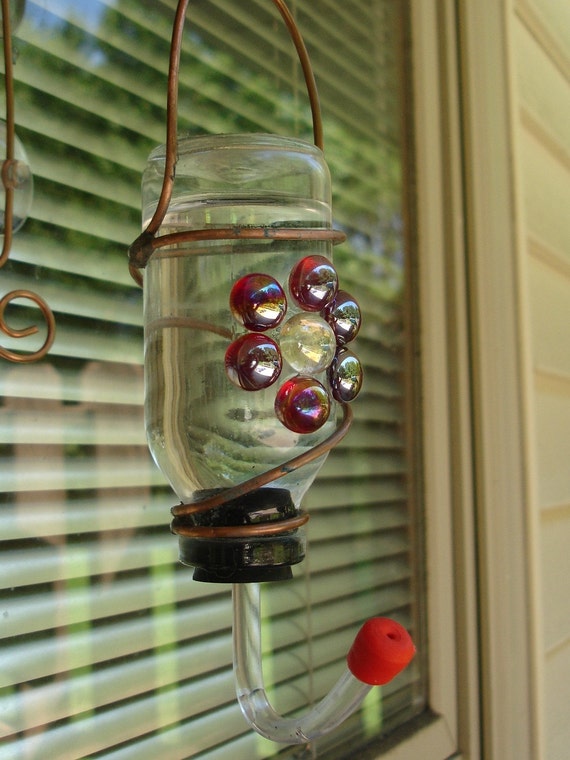 Hummingbird window feeder from recycled bottle and red stained glass