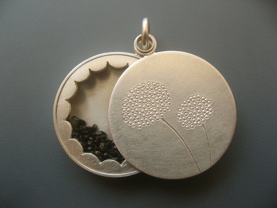 Silver valentine locket with forget-me-not-seeds