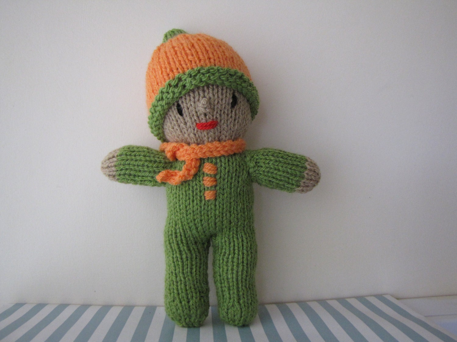 Green and orange knitted doll