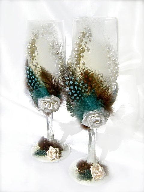 Wedding champagne glasses with feathers roses and pearls toasting flutes