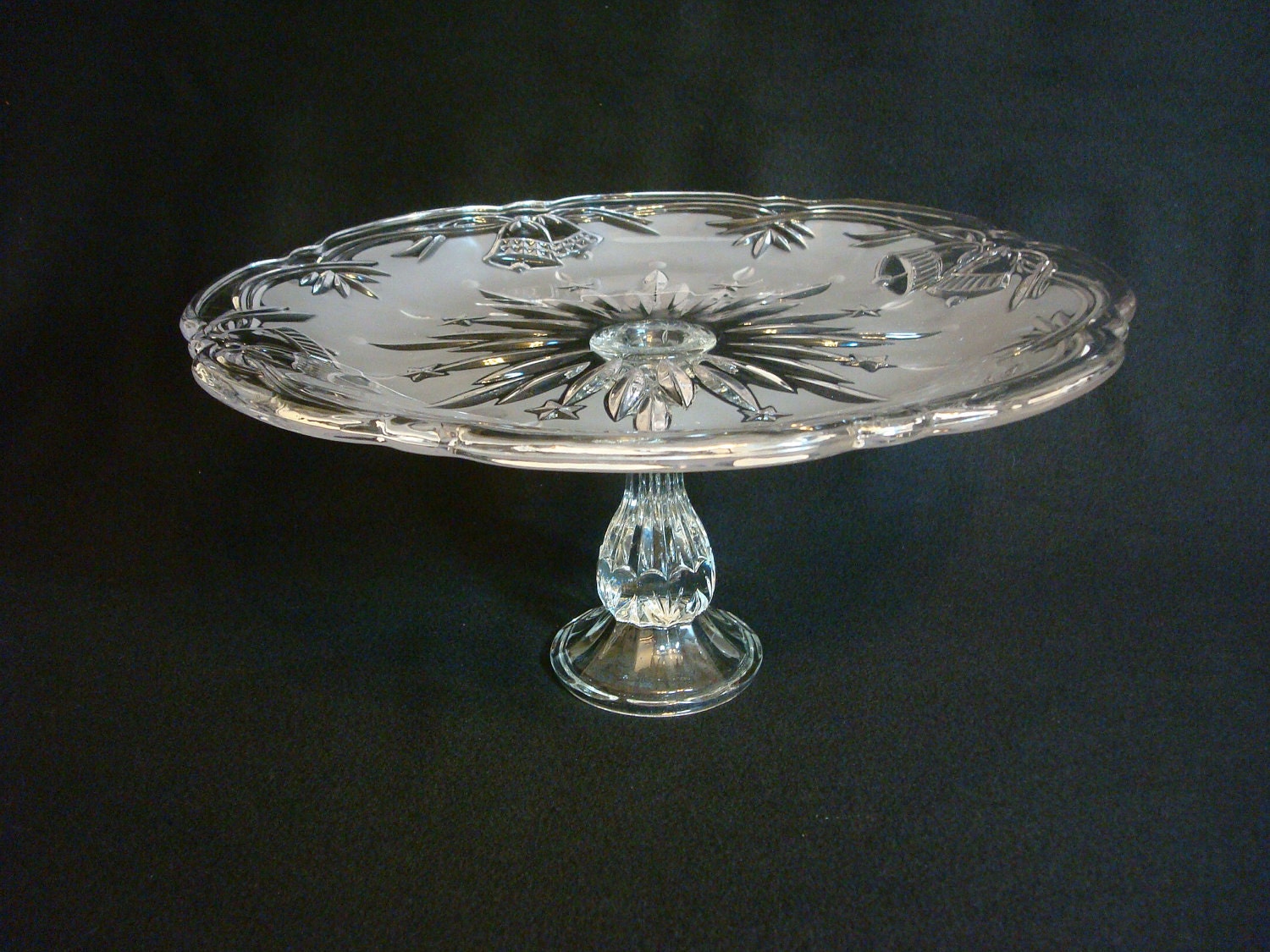 Short pedestal wedding cake stand made with re-purposed glass.  Frosted glass with wedding bells.