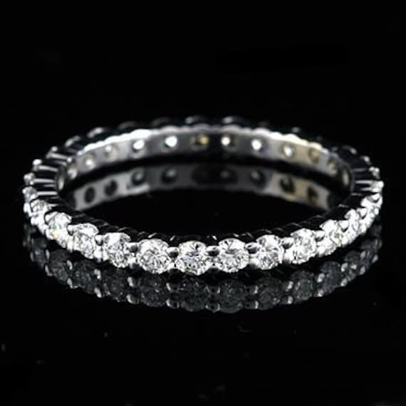 This eternity diamond band is made of 18k white gold and is 21 mm wide