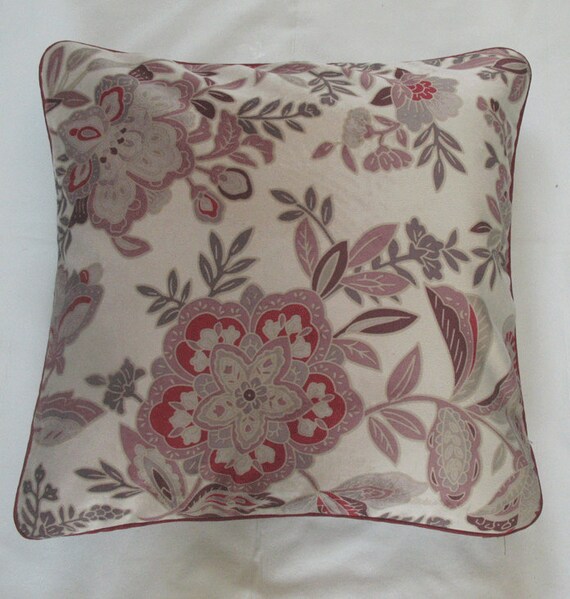 cream throw pillow with floral design