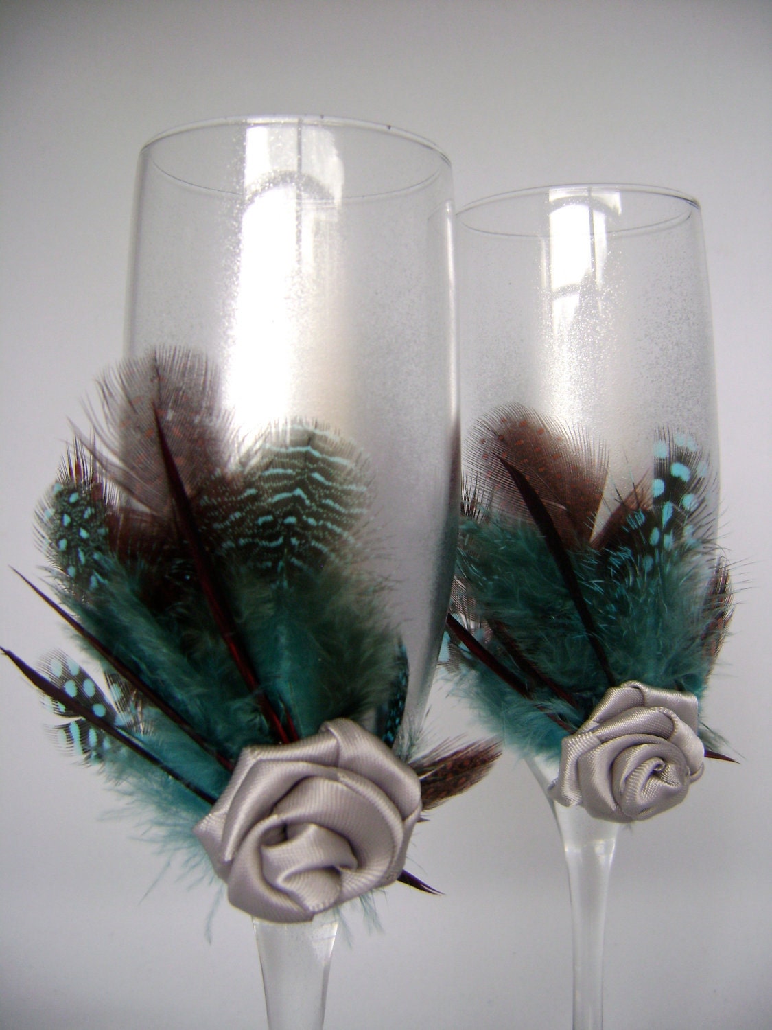 Silver teal wedding champagne glasses hand decorated with feathers and