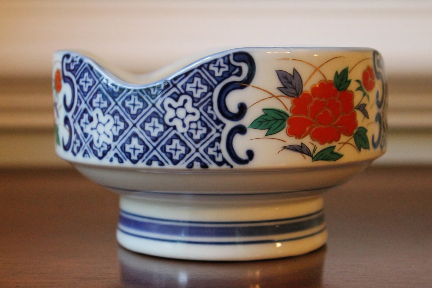 Blue and white asian bowl with red flowers
