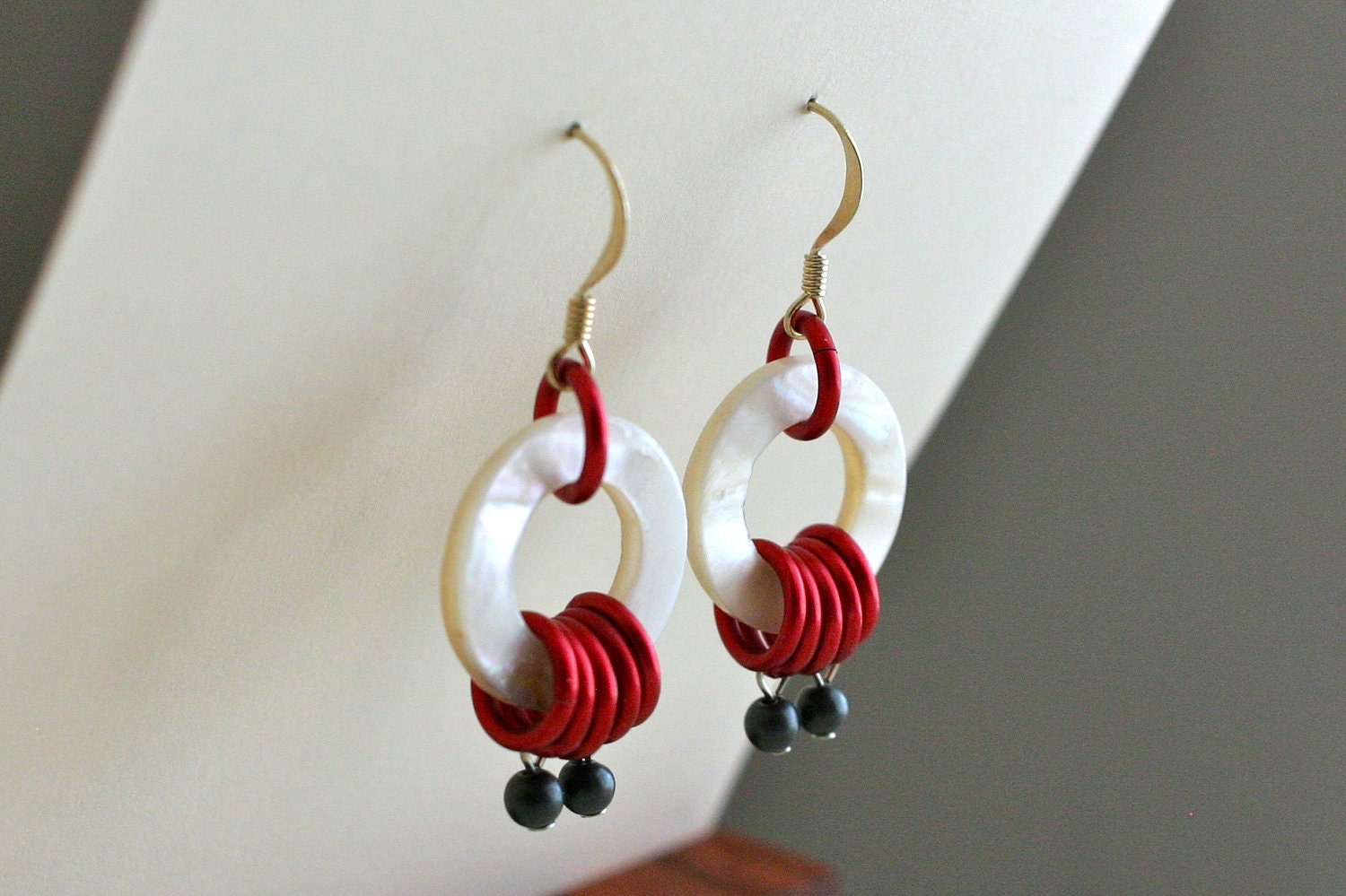 Photo: Mother of Pearl and Red Ring Earrings - White Mother of Pearl Hoops, Red Chain Rings, Matte Grey Beads by andreaturinijewelry