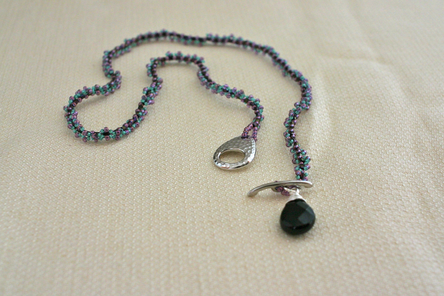 Photo: Beaded Necklace with Black Facetted Pendant and Hammered Toggle Clasp - Aqua, Teal Green, Magenta, Wire Wrapped Silver by andreaturinijewelry