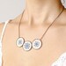 Cross stitch necklace with three navy blue ornament in bronze