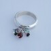 Sterling siver charm ring with emerald, tormaline and garnet beads