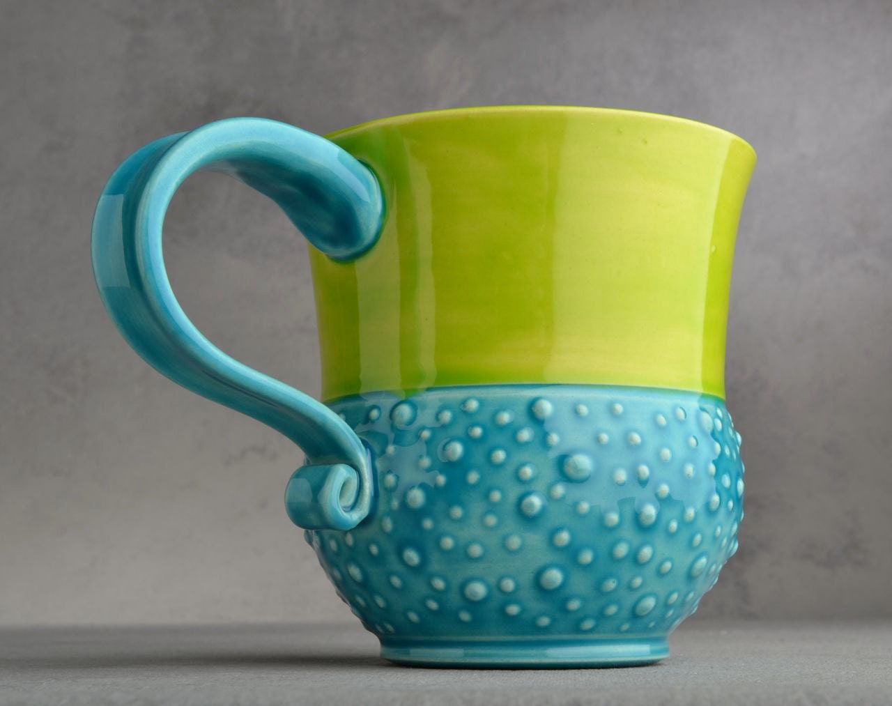 Curvy Dottie Mug: Caribbean Blue Neon Green Curvy Dottie Mug by Symmetrical Pottery