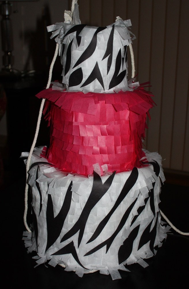 This pinata is decorated in white with black animal print 