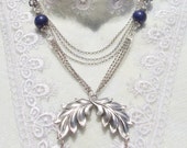 Lapis bead necklace with multiple silver chains and silver flower and leaf accents