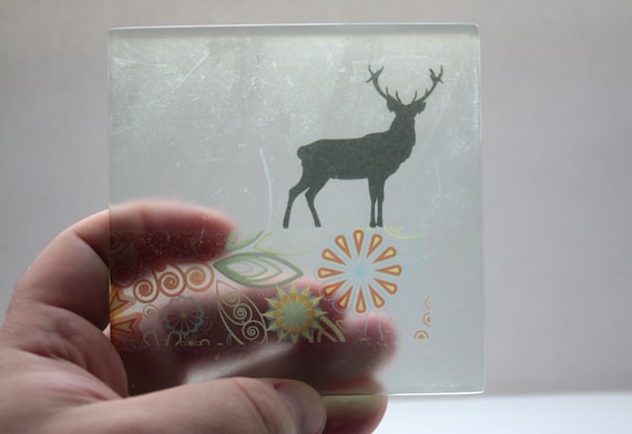 Fused glass tile in a square shape with a black by madebymanos